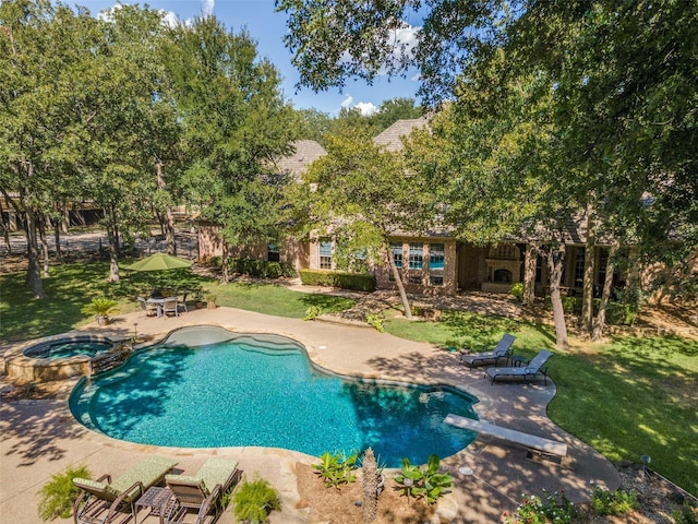 view of swimming pool with a yard, a diving board, a pool with connected hot tub, and a patio area