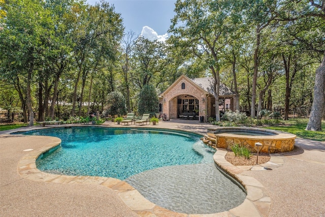 view of pool with an outdoor structure, a pool with connected hot tub, and a patio area
