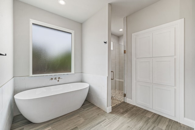 285 Lake Ridge Ct, Bluff Dale, TX 76433 - bathroom with a shower stall, a freestanding bath, tile walls, and recessed lighting