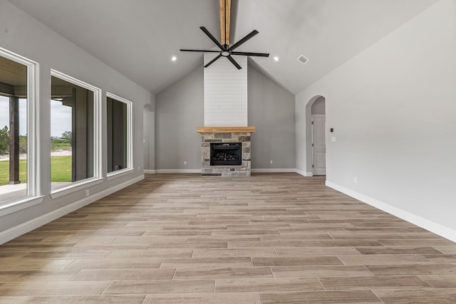 285 Lake Ridge Ct, Bluff Dale, TX 76433 - unfurnished living room with ceiling fan, light wood finished floors, arched walkways, a fireplace, and high vaulted ceiling