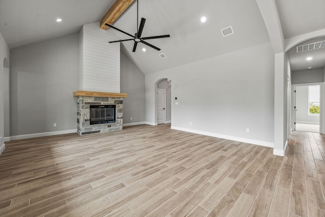 285 Lake Ridge Ct, Bluff Dale, TX 76433 - unfurnished living room with ceiling fan, arched walkways, beam ceiling, high vaulted ceiling, and light wood-style floors