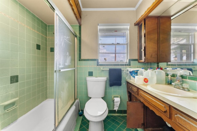 full bathroom featuring tile walls, tile patterned floors, vanity, toilet, and enclosed tub / shower combo
