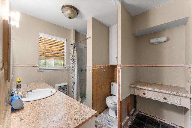 full bathroom with toilet, visible vents, tiled shower, and vanity