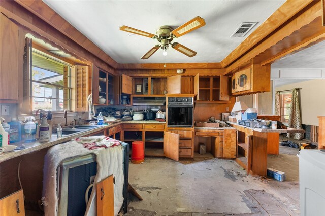 kitchen featuring a sink, a wealth of natural light, visible vents, and oven