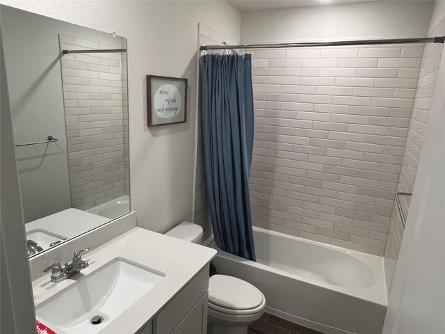 bathroom with vanity, toilet, and shower / bath combination with curtain