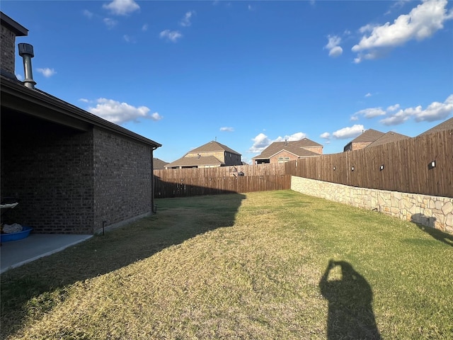 view of yard with a fenced backyard