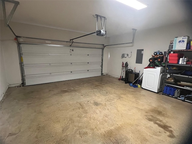 garage with a garage door opener, washer / clothes dryer, and electric panel