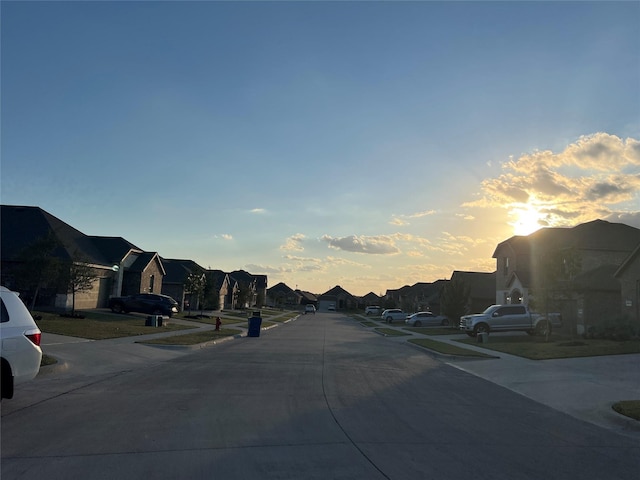 view of road with a residential view, sidewalks, and curbs