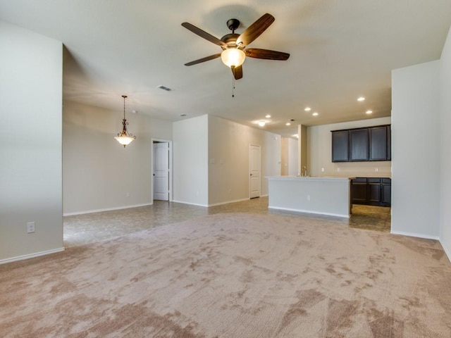unfurnished living room featuring visible vents, light carpet, baseboards, recessed lighting, and a ceiling fan