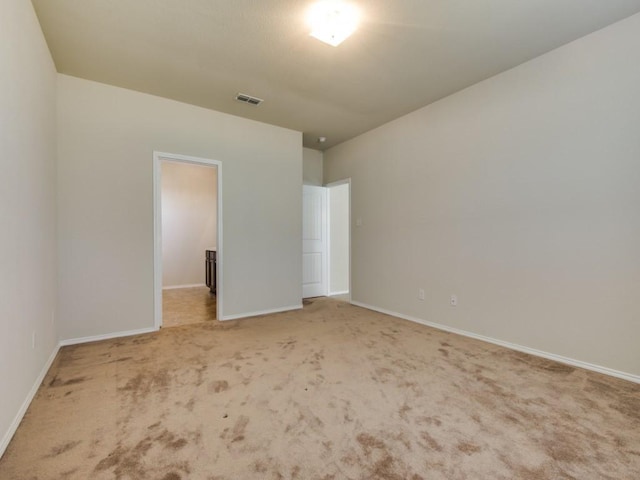 unfurnished bedroom featuring visible vents, baseboards, and carpet floors