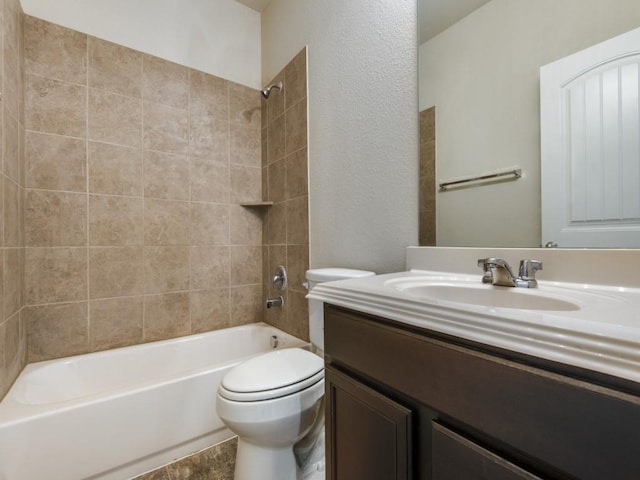 full bathroom with vanity, a textured wall, toilet, and shower / washtub combination