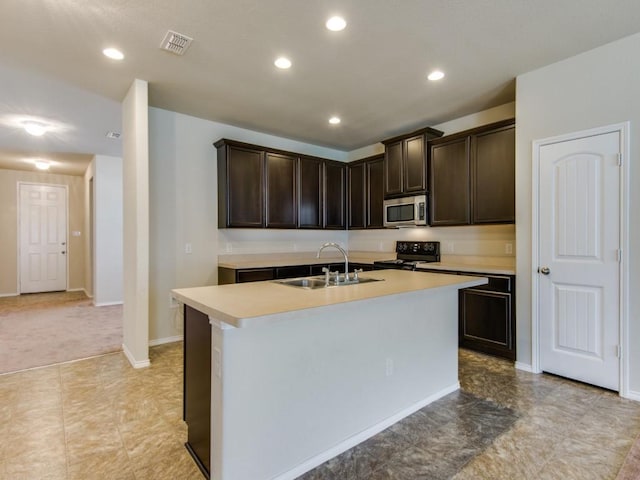 kitchen with dark brown cabinets, a sink, stainless steel microwave, black range with electric cooktop, and visible vents