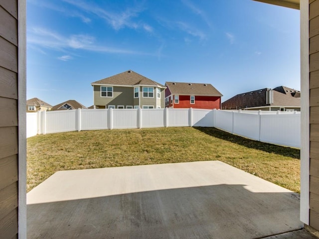 view of yard with a patio, a residential view, and a fenced backyard