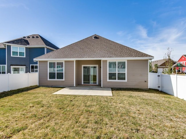 back of property with a fenced backyard, a patio, and a lawn