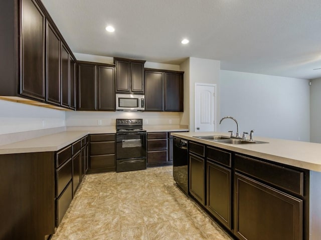 kitchen with a sink, light countertops, dark brown cabinetry, and black appliances