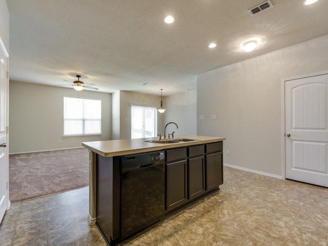 kitchen with visible vents, a ceiling fan, a kitchen island with sink, black dishwasher, and a sink