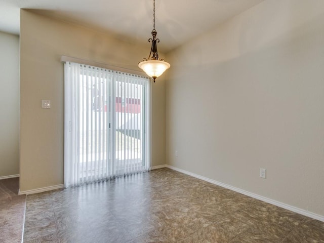 unfurnished room featuring baseboards