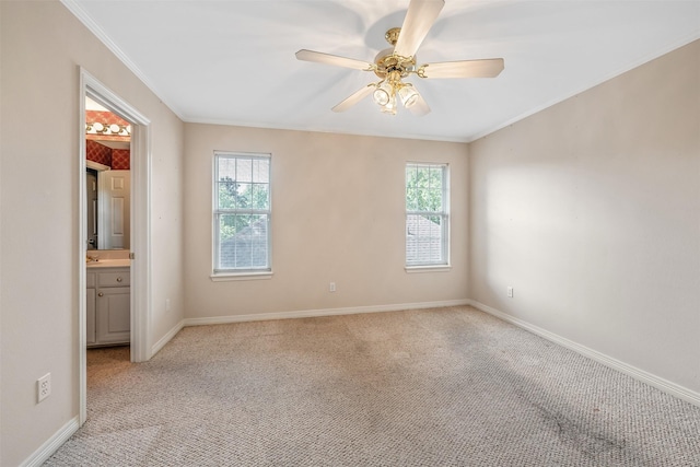 unfurnished bedroom featuring crown molding, multiple windows, and light carpet