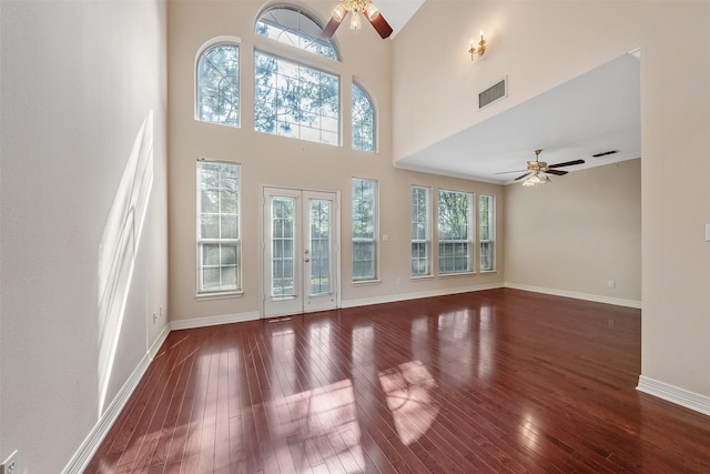 unfurnished living room featuring a ceiling fan, visible vents, and hardwood / wood-style flooring