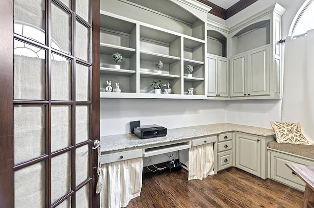 unfurnished office featuring built in study area, ornamental molding, and dark wood-style floors