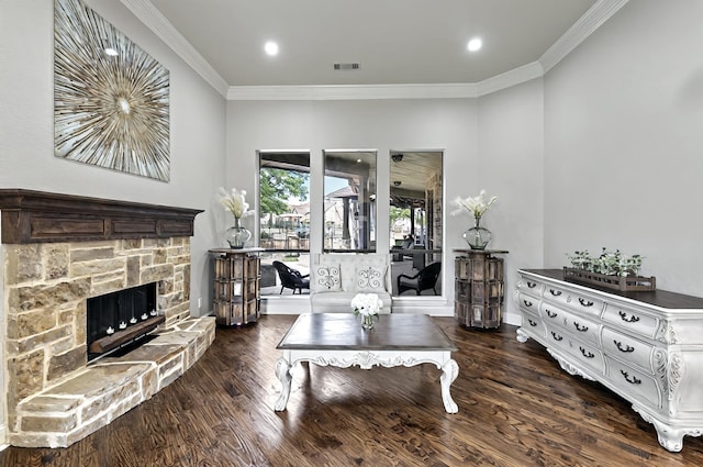 living room with ornamental molding, a fireplace, wood finished floors, and visible vents