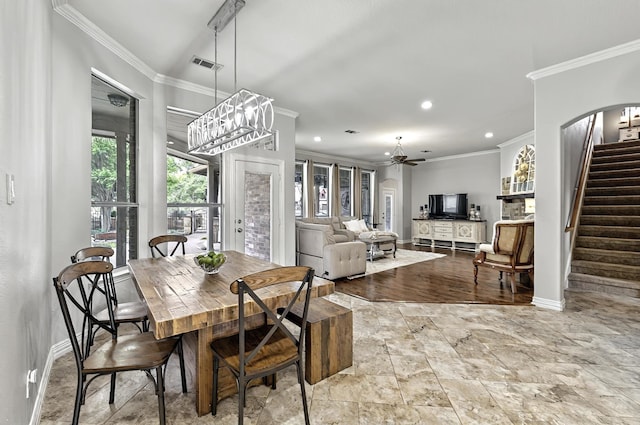 dining space featuring visible vents, crown molding, stairway, baseboards, and a chandelier