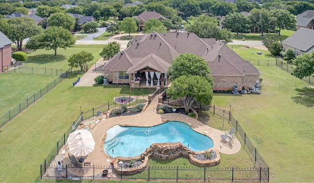 community pool featuring a lawn, a patio, and a fenced backyard