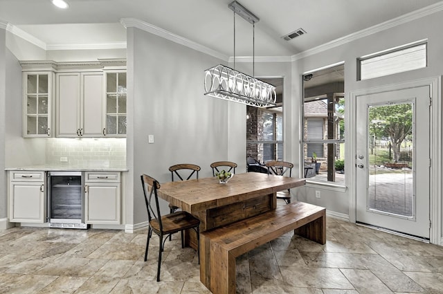 dining room featuring crown molding, beverage cooler, baseboards, and visible vents