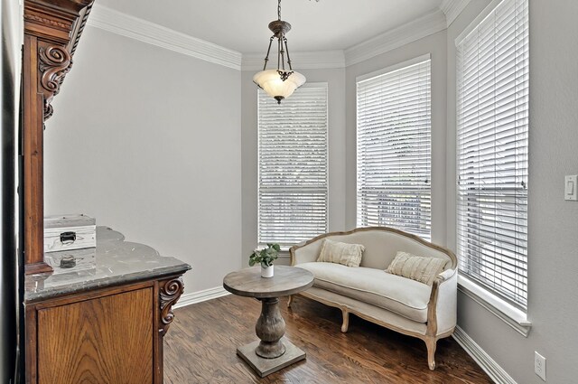 living area with baseboards, ornamental molding, and dark wood finished floors