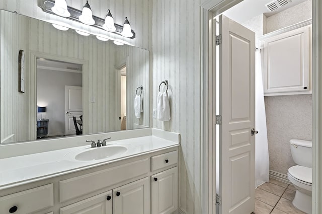 bathroom with vanity, toilet, tile patterned floors, wallpapered walls, and visible vents