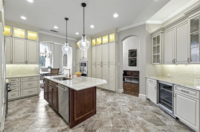 4609 Trotter Ln, Flower Mound, TX 75028 - kitchen featuring wine cooler, stainless steel appliances, a sink, ornamental molding, and arched walkways