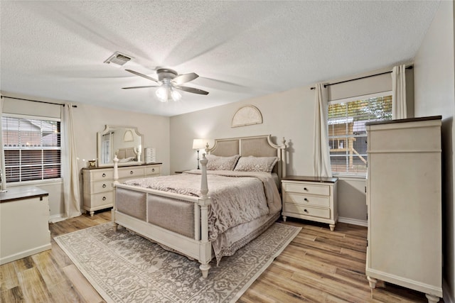 695 SE 32nd St, Paris, TX 75460 - bedroom featuring visible vents, a textured ceiling, baseboards, and light wood-type flooring