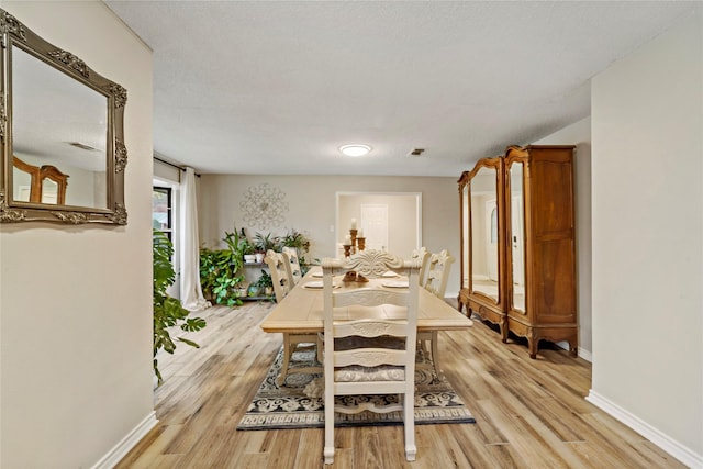 695 SE 32nd St, Paris, TX 75460 - dining space featuring light wood-style floors and baseboards