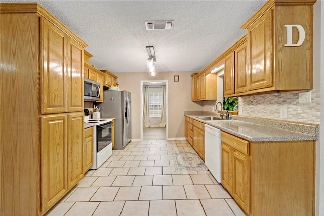 695 SE 32nd St, Paris, TX 75460 - kitchen with light tile patterned flooring, a sink, white appliances, tasteful backsplash, and visible vents
