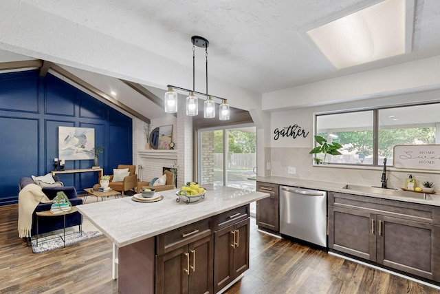 3965 Singleleaf Ln, Fort Worth, TX 76133 - kitchen featuring stainless steel dishwasher, a sink, dark wood finished floors, a brick fireplace, and hanging light fixtures