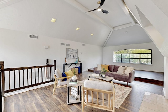 living room featuring visible vents, ceiling fan, wood finished floors, and vaulted ceiling with beams