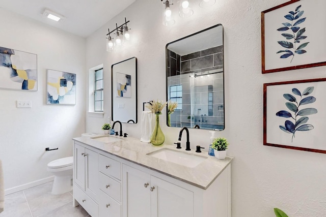 3965 Singleleaf Ln, Fort Worth, TX 76133 - bathroom with a shower stall, toilet, double vanity, tile patterned floors, and baseboards