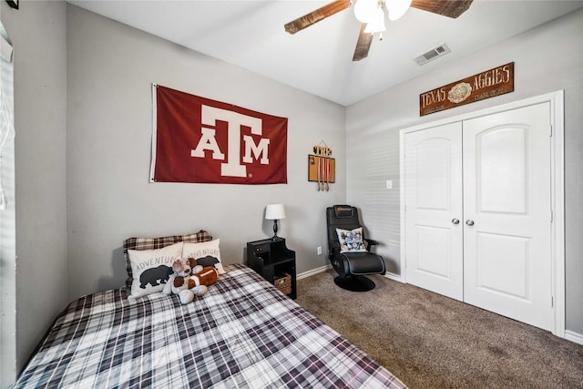 carpeted bedroom with a closet, baseboards, a ceiling fan, and visible vents