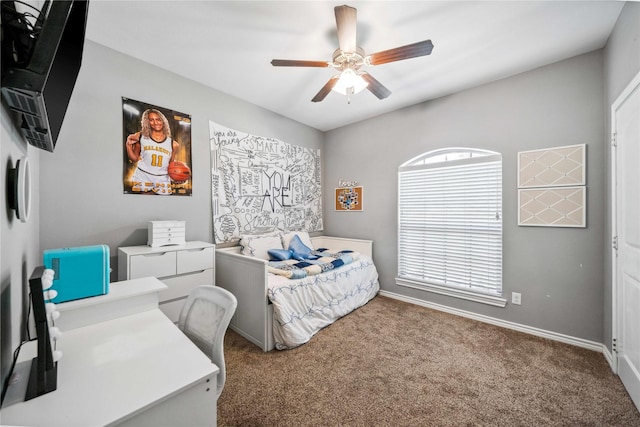 carpeted bedroom featuring baseboards and ceiling fan