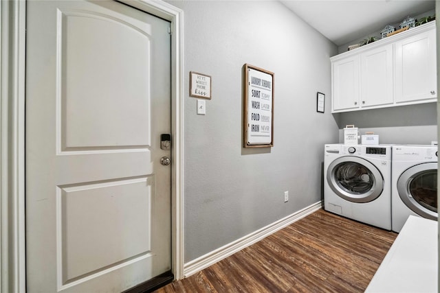 laundry area with baseboards, dark wood-type flooring, cabinet space, and washer and dryer