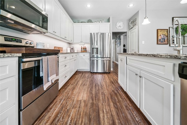 kitchen featuring white cabinets, appliances with stainless steel finishes, and dark wood-style floors