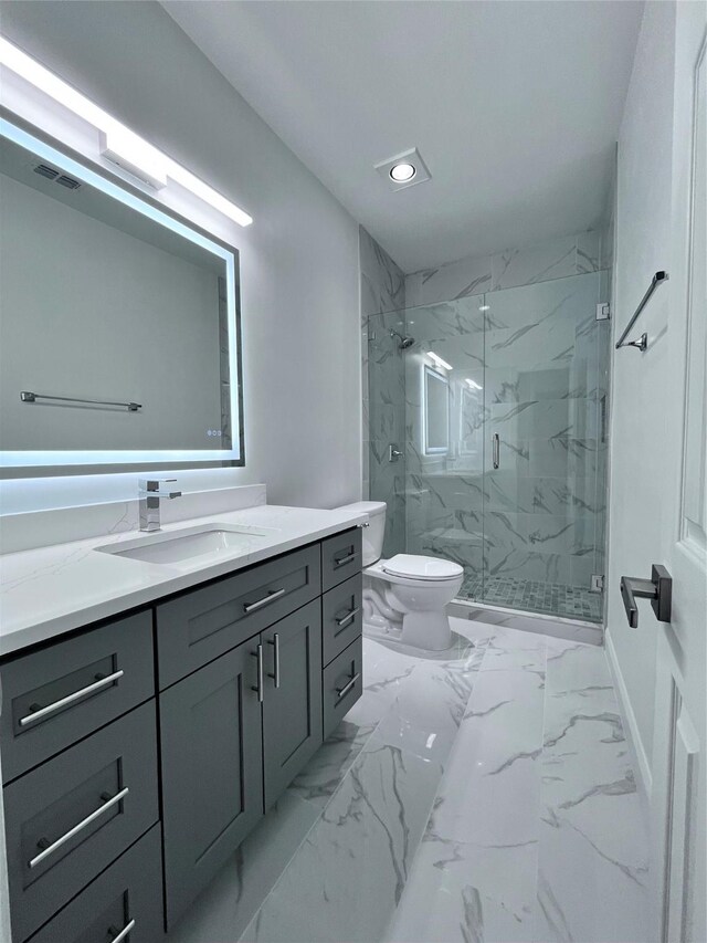 bathroom with a marble finish shower, vanity, toilet, and marble finish floor