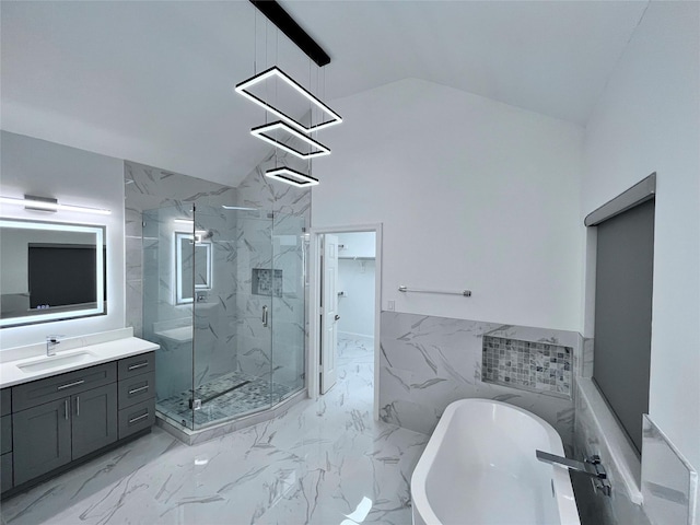 full bathroom with vaulted ceiling, vanity, a wainscoted wall, a marble finish shower, and a soaking tub