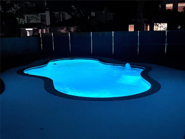 view of swimming pool with a fenced in pool and fence