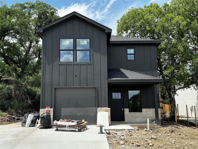modern inspired farmhouse with a garage, a shingled roof, board and batten siding, and driveway