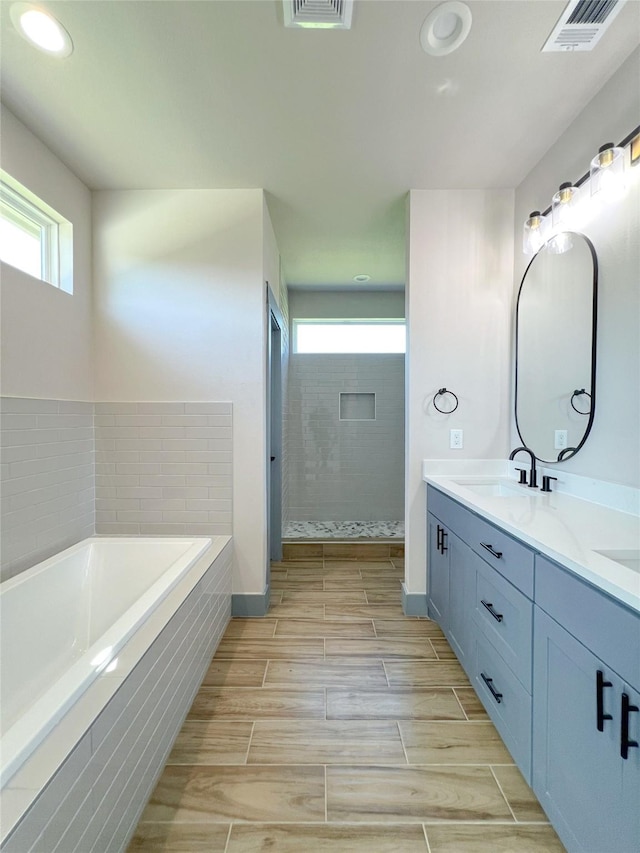 5008 San Marcos Dr, Granbury, TX 76048 - bathroom featuring plenty of natural light, a bath, double vanity, recessed lighting, and tiled shower