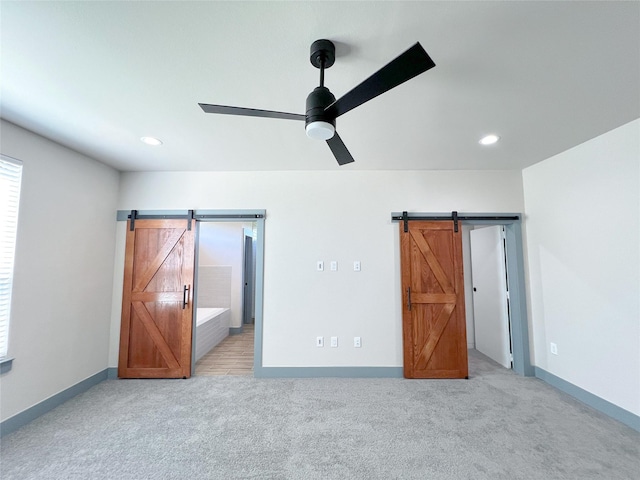 5008 San Marcos Dr, Granbury, TX 76048 - unfurnished bedroom with a barn door, light carpet, recessed lighting, and baseboards
