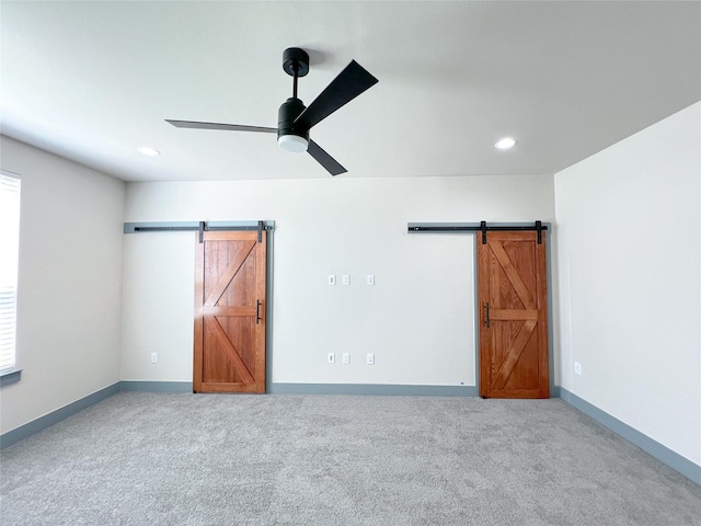 5008 San Marcos Dr, Granbury, TX 76048 - unfurnished bedroom with a barn door, carpet, recessed lighting, ceiling fan, and baseboards