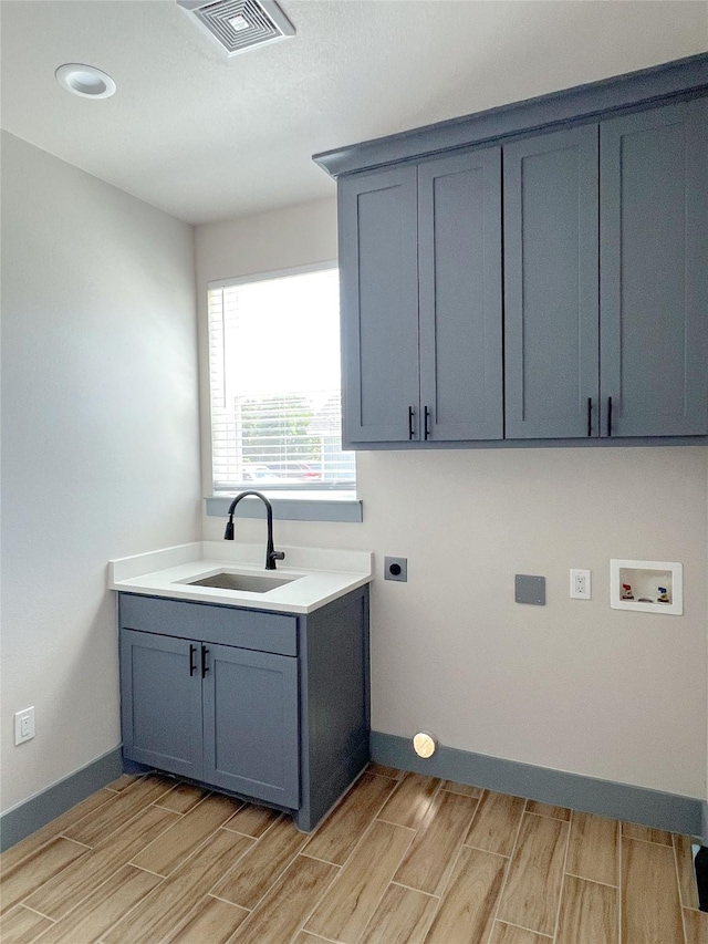 5008 San Marcos Dr, Granbury, TX 76048 - clothes washing area with washer hookup, wood finish floors, electric dryer hookup, and baseboards