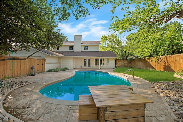 view of swimming pool featuring a patio, a fenced backyard, a yard, and a fenced in pool